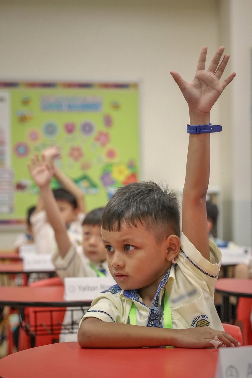 Picture of a student raising her hand to ask for permission
